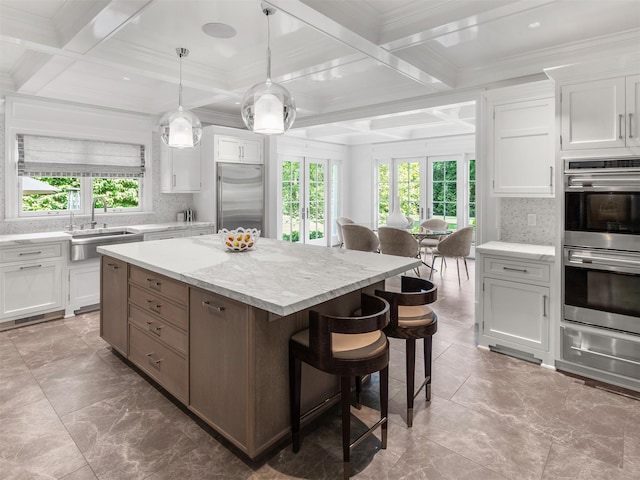 27 Red Ground Rd, Old Westbury, NY 11568 - kitchen featuring stainless steel appliances, coffered ceiling, white cabinets, backsplash, and beam ceiling