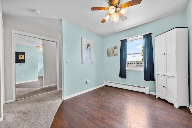 1548 Rte 9 Unit 7C, Wappingers Falls, NY 12590 - unfurnished bedroom featuring a baseboard radiator, wood finished floors, and ceiling fan