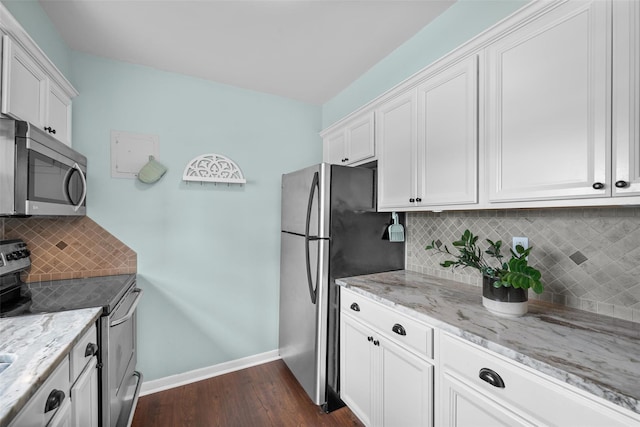 1548 Rte 9 Unit 7C, Wappingers Falls, NY 12590 - kitchen with appliances with stainless steel finishes, dark wood-style flooring, white cabinets, and light stone counters