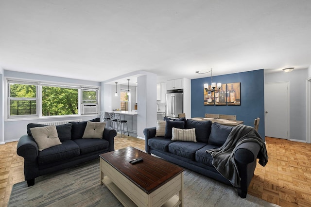 4525 Henry Hudson Pkwy Unit 204, Bronx, NY 10471 - living room featuring a chandelier, baseboards, and cooling unit