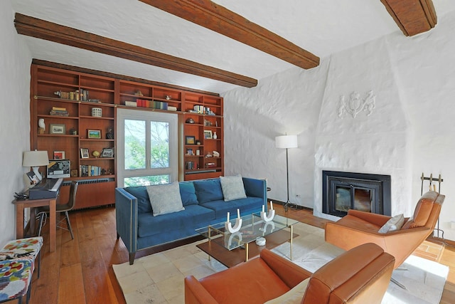 286 Lyncroft Rd, New Rochelle, NY 10804 - living room with beam ceiling, a large fireplace, built in features, wood finished floors, and radiator