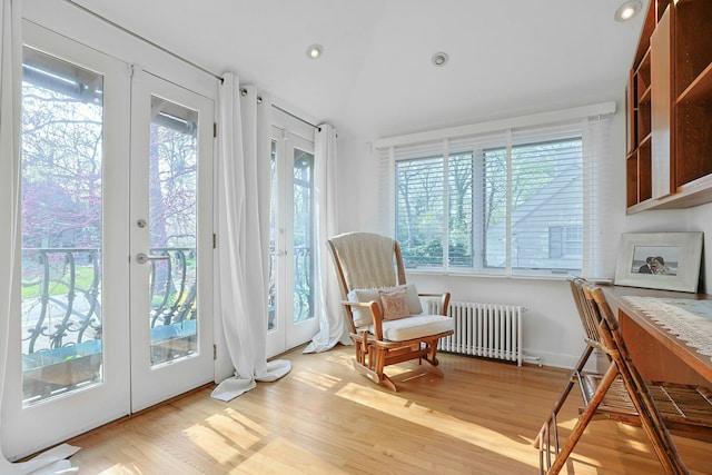 286 Lyncroft Rd, New Rochelle, NY 10804 - living area featuring radiator heating unit, french doors, wood finished floors, recessed lighting, and vaulted ceiling