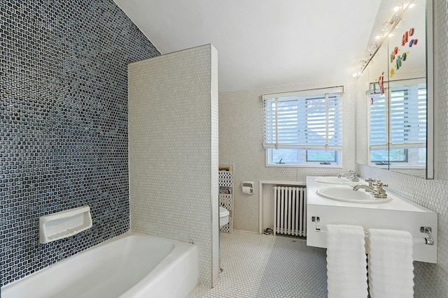 286 Lyncroft Rd, New Rochelle, NY 10804 - bathroom with radiator, tile walls, a tub to relax in, and double vanity