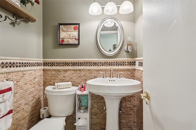 438 Genesee Ct, Suffern, NY 10901 - half bath featuring a wainscoted wall and tile walls