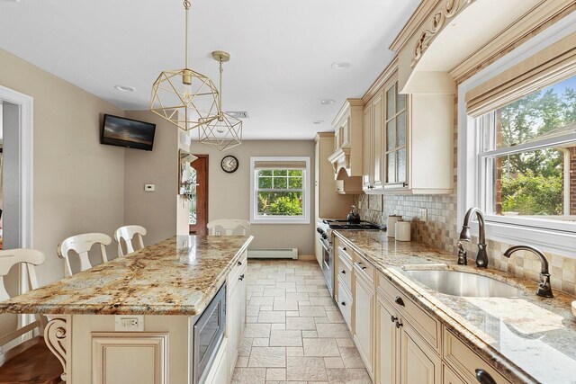 15707 22nd Ave, Whitestone, NY 11357 - kitchen with cream cabinetry, appliances with stainless steel finishes, a sink, baseboards, and glass insert cabinets