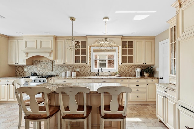 15707 22nd Ave, Whitestone, NY 11357 - kitchen featuring cream cabinets, decorative backsplash, a kitchen bar, and stone tile floors
