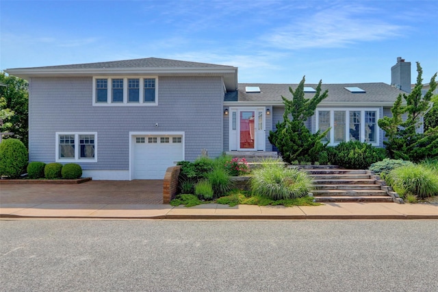 62 Woodhail St, Lido Beach, NY 11561 - split level home featuring driveway, an attached garage, a chimney, and roof with shingles