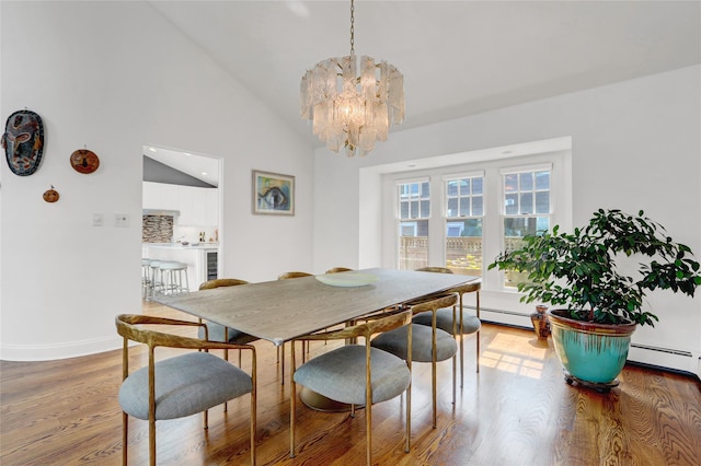 62 Woodhail St, Lido Beach, NY 11561 - dining room with a chandelier, wood finished floors, vaulted ceiling, baseboards, and a baseboard radiator