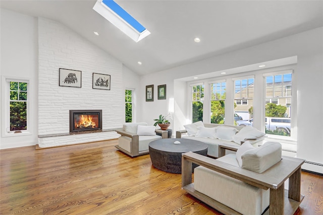 62 Woodhail St, Lido Beach, NY 11561 - living area featuring a fireplace, light wood-style floors, a skylight, recessed lighting, and high vaulted ceiling