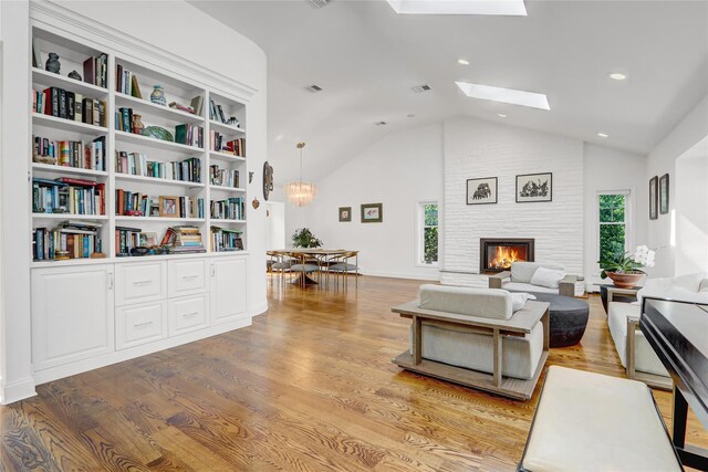 62 Woodhail St, Lido Beach, NY 11561 - living area featuring a skylight, light wood-style flooring, a fireplace, high vaulted ceiling, and recessed lighting
