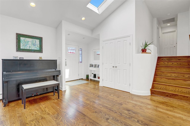 62 Woodhail St, Lido Beach, NY 11561 - entryway with a skylight, wood finished floors, stairway, vaulted ceiling, and baseboards