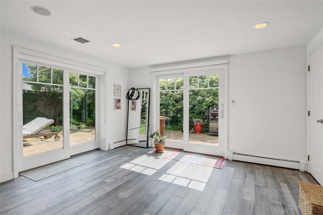 62 Woodhail St, Lido Beach, NY 11561 - doorway featuring baseboard heating, plenty of natural light, wood finished floors, and recessed lighting