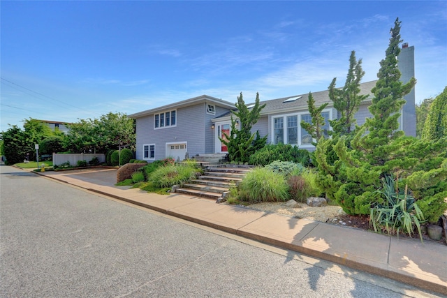 62 Woodhail St, Lido Beach, NY 11561 - split level home with a garage and concrete driveway