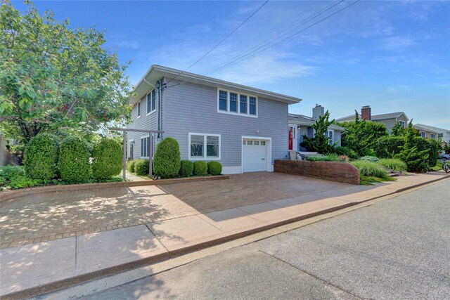 62 Woodhail St, Lido Beach, NY 11561 - view of front of property with decorative driveway and a garage