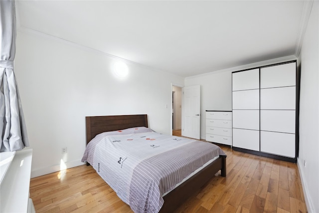 134-54 Maple Ave Unit 3W, Flushing, NY 11355 - bedroom featuring light wood-style floors, crown molding, and baseboards