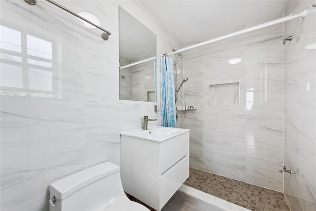 134-54 Maple Ave Unit 3W, Flushing, NY 11355 - full bathroom featuring vanity, toilet, a marble finish shower, and tile walls