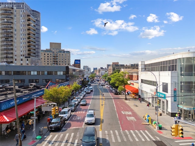 134-54 Maple Ave Unit 3W, Flushing, NY 11355 - view of asphalt street with a city view, street lights, and sidewalks