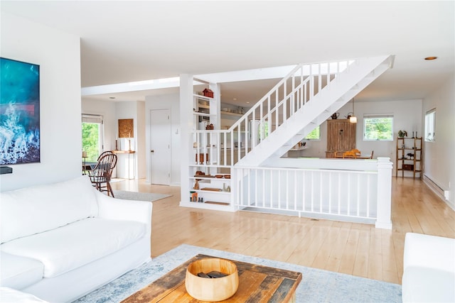 13 W Shore Rd, Kauneonga Lake, NY 12749 - living area with stairway, hardwood / wood-style floors, healthy amount of natural light, and baseboards