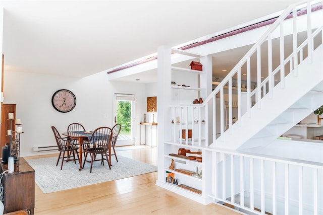13 W Shore Rd, Kauneonga Lake, NY 12749 - dining area with wood finished floors and a baseboard heating unit