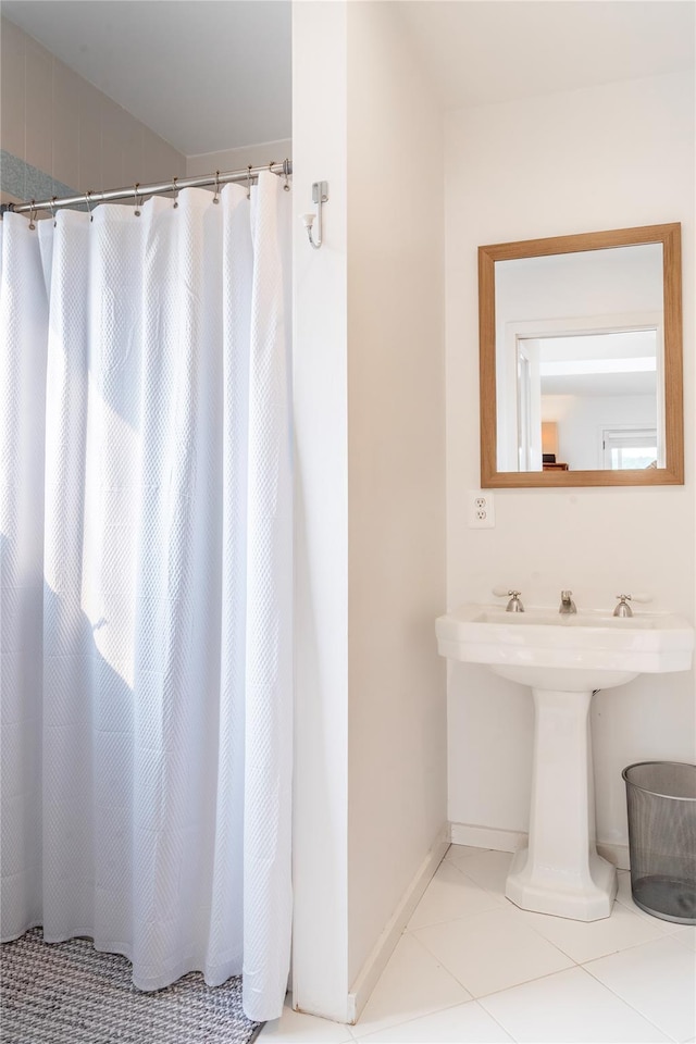13 W Shore Rd, Kauneonga Lake, NY 12749 - bathroom with baseboards, tile patterned flooring, a sink, and a shower with curtain