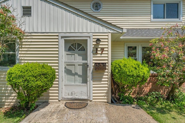 17 Linn Pl, Yonkers, NY 10705 - doorway to property with board and batten siding and roof with shingles