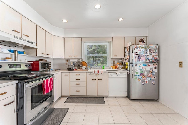 17 Linn Pl, Yonkers, NY 10705 - kitchen with appliances with stainless steel finishes, light countertops, under cabinet range hood, light tile patterned floors, and recessed lighting