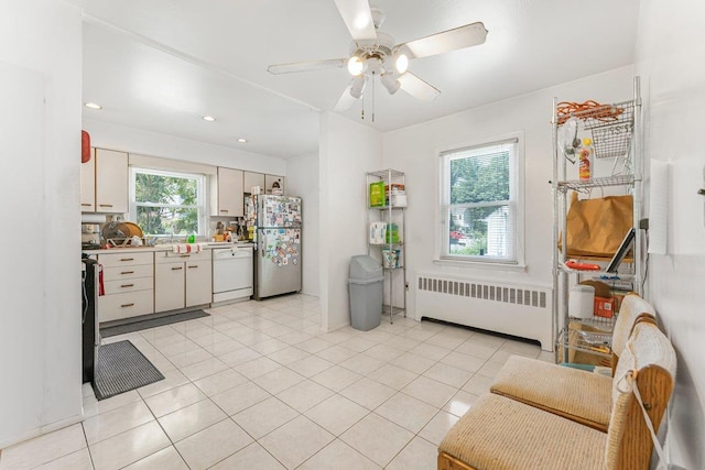 17 Linn Pl, Yonkers, NY 10705 - kitchen with radiator, freestanding refrigerator, white dishwasher, ceiling fan, and light countertops