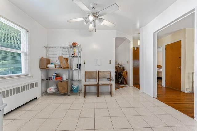17 Linn Pl, Yonkers, NY 10705 - bedroom featuring radiator, arched walkways, multiple windows, and ceiling fan