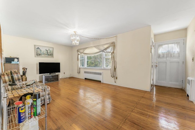 17 Linn Pl, Yonkers, NY 10705 - living area with radiator heating unit, hardwood / wood-style floors, and a chandelier