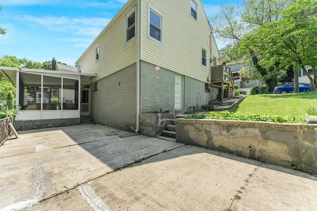 17 Linn Pl, Yonkers, NY 10705 - back of house with a sunroom, a patio, a lawn, a chimney, and entry steps