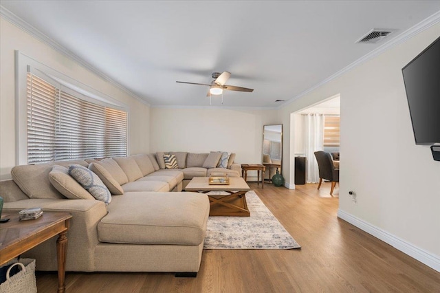 105 Shoreham Way, Merrick, NY 11566 - living area featuring ceiling fan, crown molding, wood finished floors, and baseboards