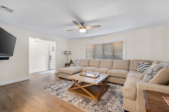 105 Shoreham Way, Merrick, NY 11566 - living area with a ceiling fan, wood finished floors, ornamental molding, and baseboards