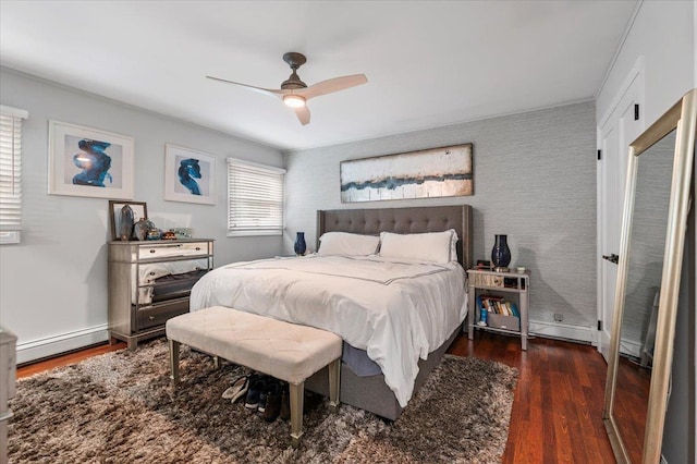 105 Shoreham Way, Merrick, NY 11566 - bedroom featuring baseboard heating, wood finished floors, ceiling fan, and an accent wall