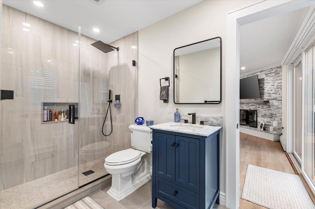 105 Shoreham Way, Merrick, NY 11566 - bathroom featuring toilet, a stall shower, vanity, a large fireplace, and recessed lighting