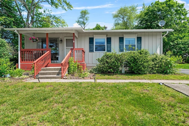 69 Wickham Dr, Warwick, NY 10990 - ranch-style house featuring a front yard and board and batten siding