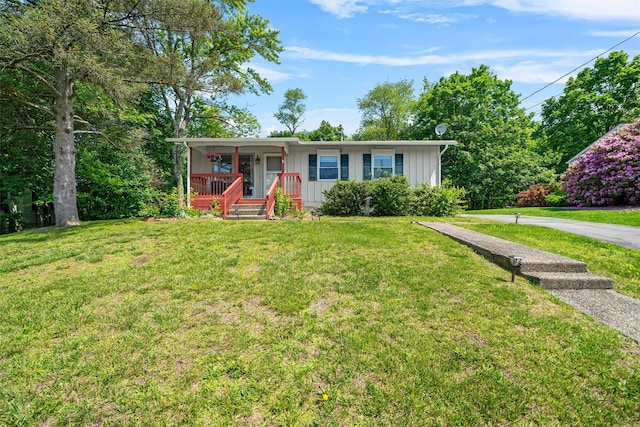 69 Wickham Dr, Warwick, NY 10990 - ranch-style house with board and batten siding, a porch, and a front yard