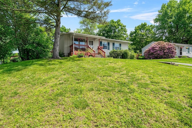 69 Wickham Dr, Warwick, NY 10990 - single story home with board and batten siding, a front lawn, and covered porch