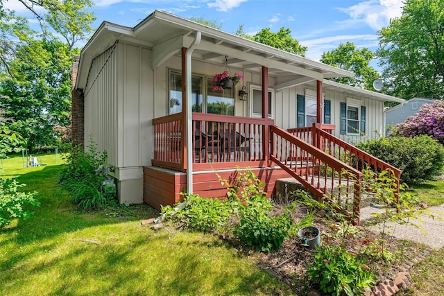 69 Wickham Dr, Warwick, NY 10990 - view of front of house featuring a front lawn, board and batten siding, and a porch