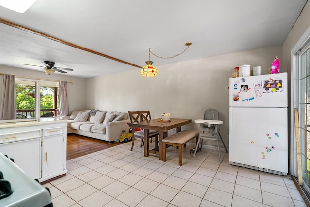 69 Wickham Dr, Warwick, NY 10990 - kitchen featuring freestanding refrigerator, white cabinets, light tile patterned floors, light countertops, and ceiling fan