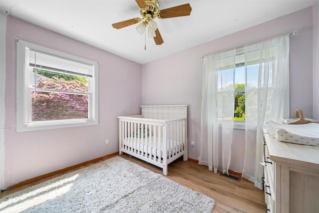 69 Wickham Dr, Warwick, NY 10990 - bedroom with multiple windows, light wood-style floors, and baseboards