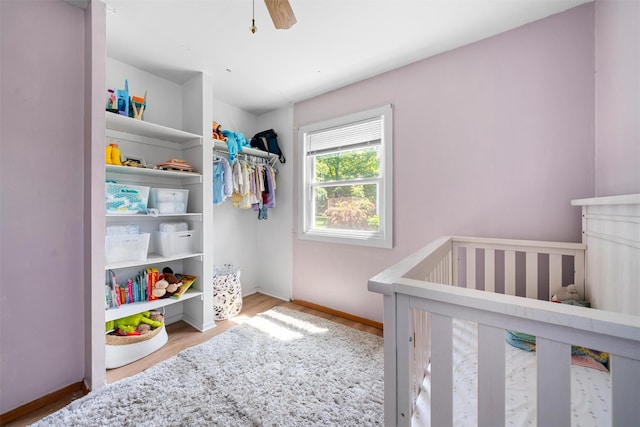 69 Wickham Dr, Warwick, NY 10990 - bedroom featuring a crib, wood finished floors, baseboards, and a ceiling fan