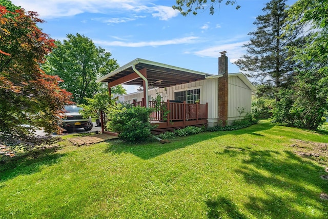 69 Wickham Dr, Warwick, NY 10990 - rear view of house with a chimney, a lawn, and a deck