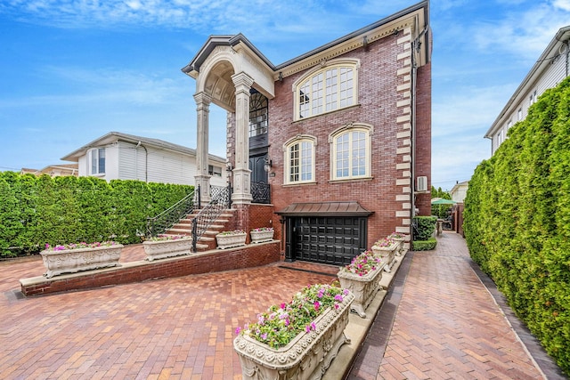 16136 90th St, Howard Beach, NY 11414 - view of front of property with brick siding, a garage, and decorative driveway