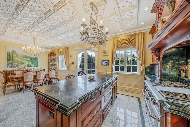 16136 90th St, Howard Beach, NY 11414 - kitchen featuring a chandelier, stainless steel range, ornamental molding, wainscoting, and hanging light fixtures