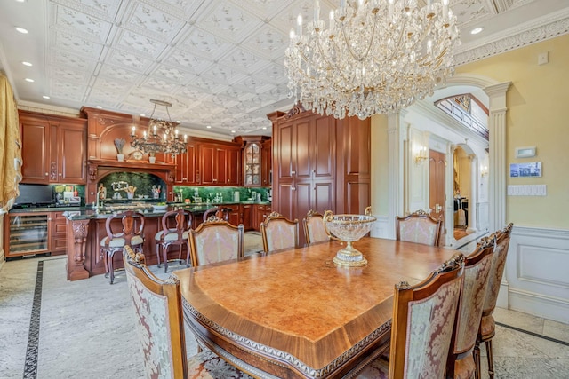 16136 90th St, Howard Beach, NY 11414 - dining area featuring a chandelier, beverage cooler, arched walkways, inlaid floor details, and crown molding