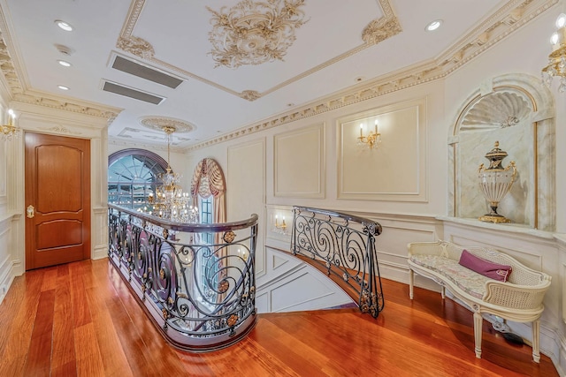 16136 90th St, Howard Beach, NY 11414 - hallway featuring crown molding, a decorative wall, light wood-type flooring, and recessed lighting