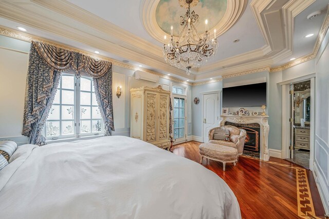 16136 90th St, Howard Beach, NY 11414 - bedroom featuring a chandelier, a wall mounted air conditioner, crown molding, wood finished floors, and a fireplace