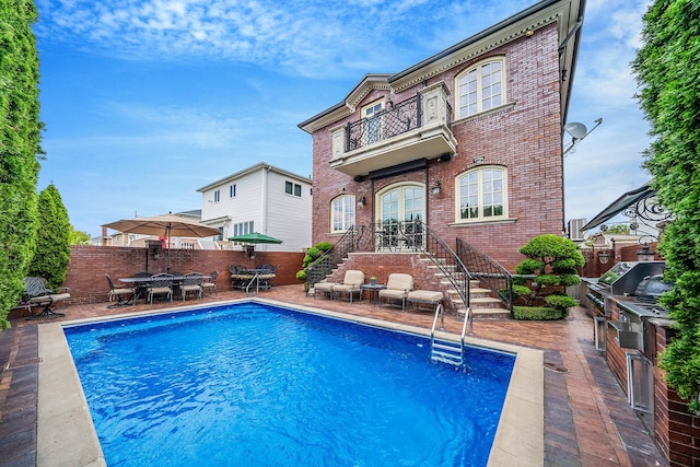 16136 90th St, Howard Beach, NY 11414 - rear view of property with brick siding, a balcony, outdoor dining space, a patio area, and a fenced backyard