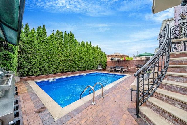16136 90th St, Howard Beach, NY 11414 - view of pool with a patio, a fenced backyard, outdoor dining area, and stairs