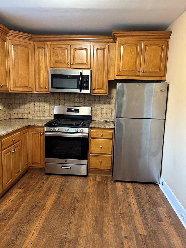 11 Fox Holw, Hillburn, NY 10931 - kitchen with stainless steel appliances, dark wood-style flooring, brown cabinetry, and backsplash